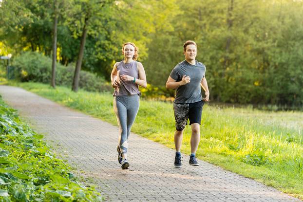 Young,Woman,And,Man,Running,In,A,Forest,And,Making