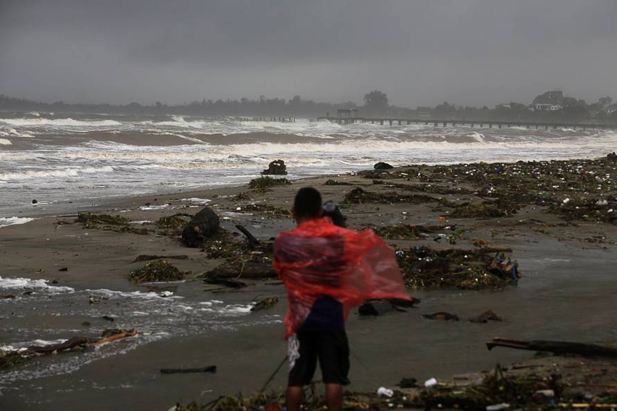 A cameraman films a beach as Hurricane Eta approaches, in Tela