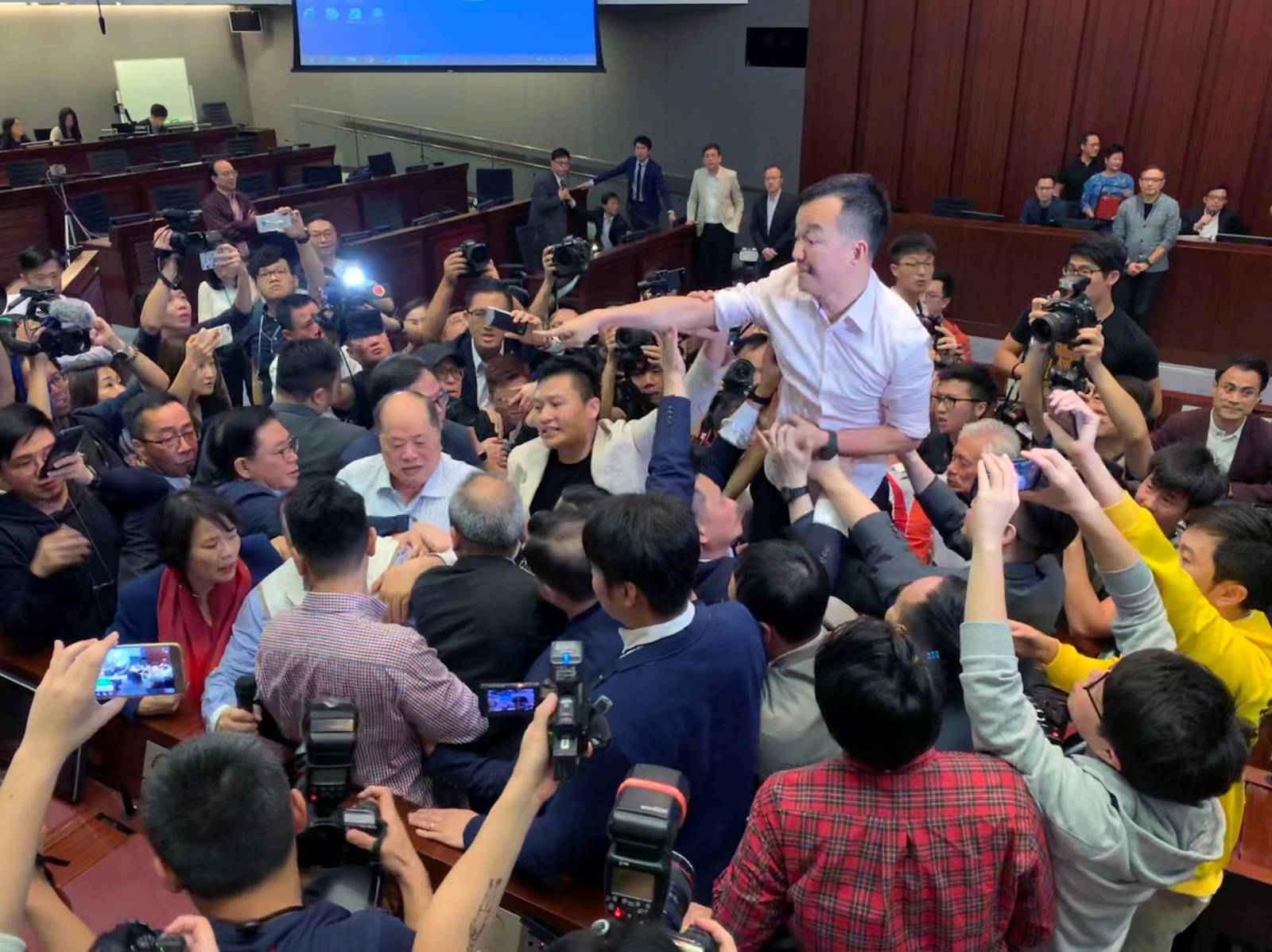 Pro-democracy lawmakers clash with pro-Beijing lawmakers during a meeting for control of a meeting room to consider the controversial extradition bill, in Hong Kong