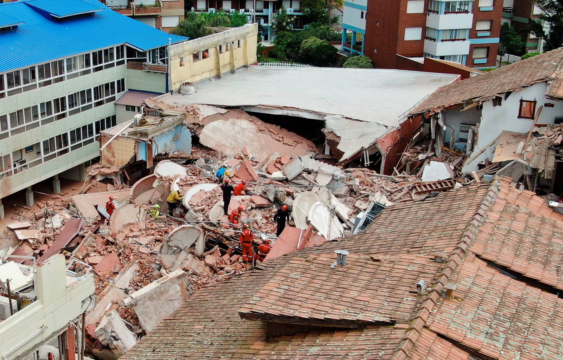 Firefighters search for trapped people after a hotel collapses in Villa Gesell