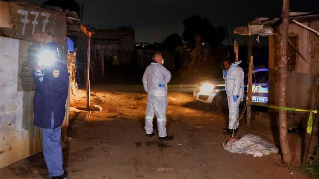 Police stand guard at the scene following a suspected gas leak thought to be linked to illegal mining