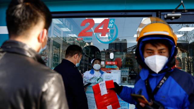 People line up to buy fever and cold medicine in Beijing