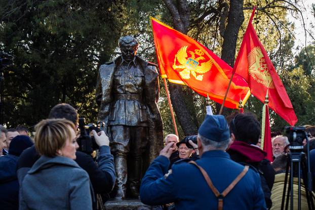 A man wearing old army uniform salutes to the monument of late Yugoslav leader Josip Broz Tito after unveiling ceremony in Podgorica