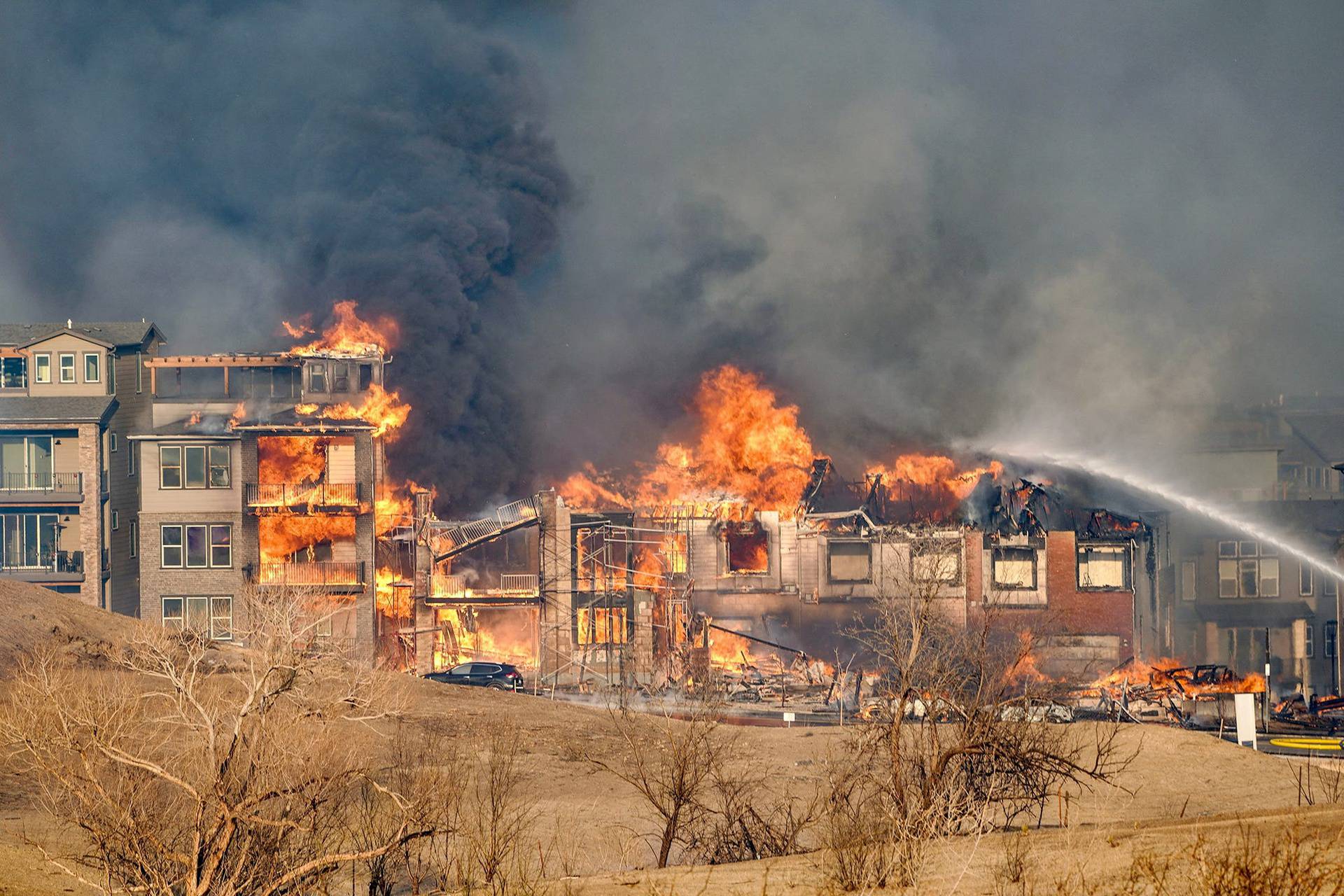 Structures burn as a wind-driven wildfire forced evacuation of Superior suburb of Boulder