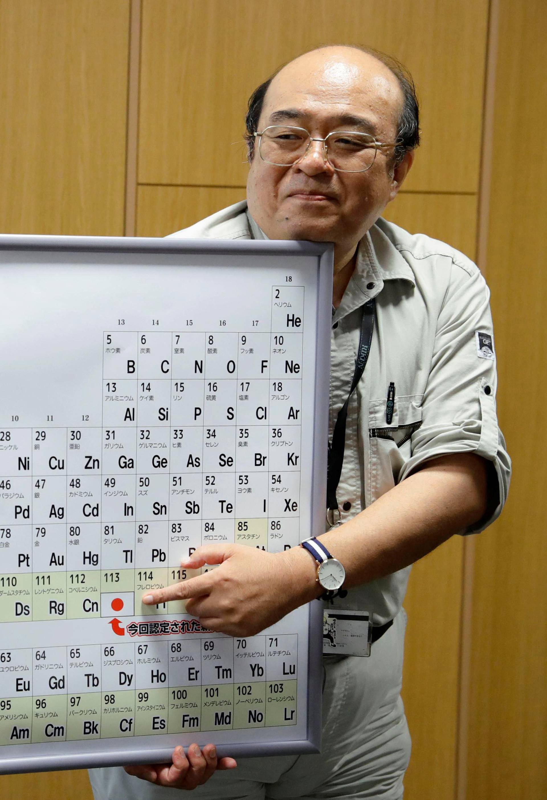 Morita points to the superheavy synthetic element on a periodic table at a news conference at the RIKEN institute's research centre in Wako