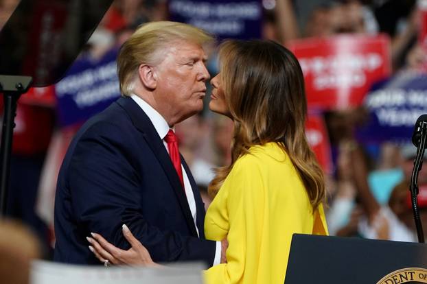 U.S. President Donald Trump and First Lady Melania Trump kiss at a campaign kick off rally at the Amway Center in Orlando