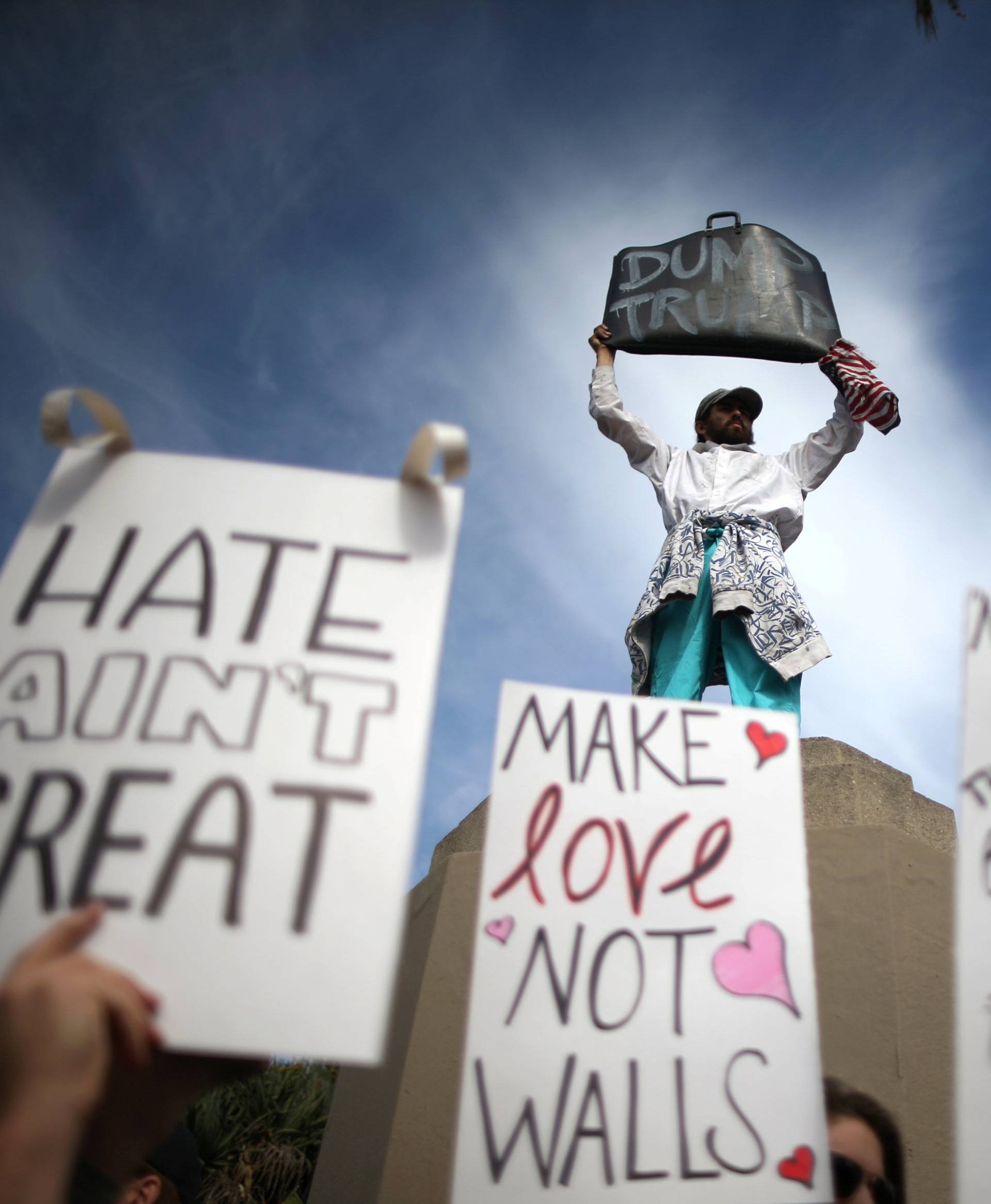 People hold signs during a march and rally against the election of Republican Donald Trump as President of the United States in Los Angeles