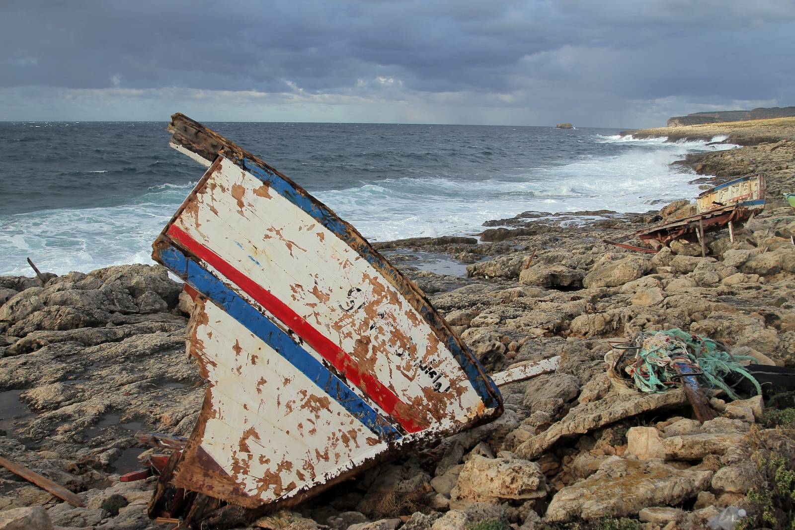 The wreckage of a boat is seen on a shore after a migrant boat capsized off the Italian coast, on the island of Lampedusa