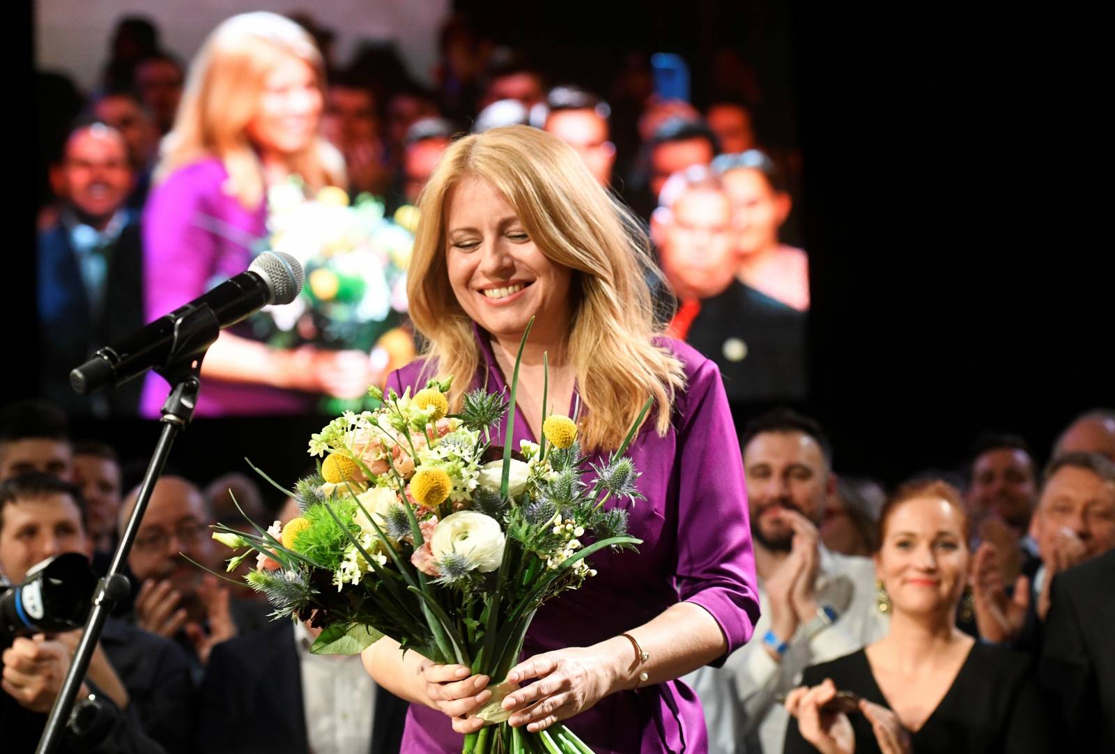 Slovakia's presidential candidate Zuzana Caputova receives flowers after winning the presidential election, at her party's headquarters in Bratislava