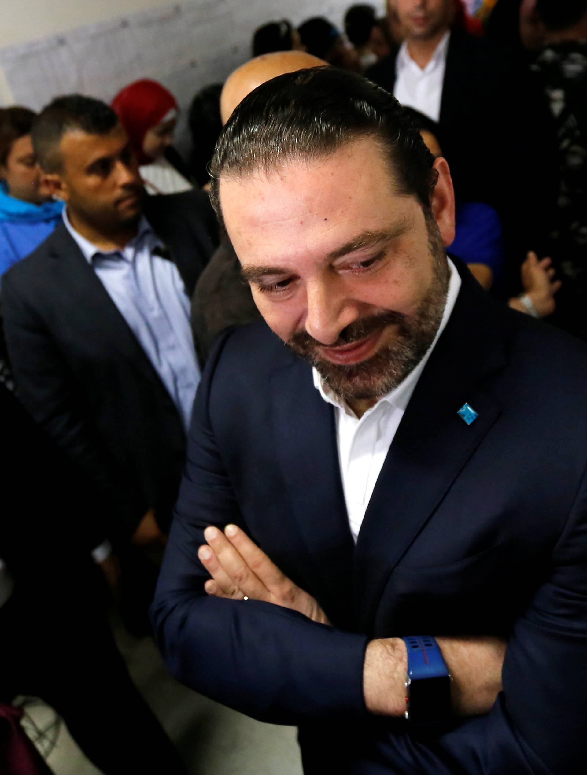 Lebanese prime minister and candidate for the parliamentary election Saad al-Hariri stands at a polling station during the parliamentary election in Beirut
