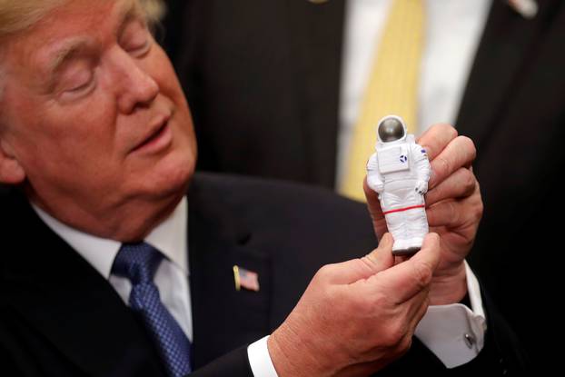 U.S. President Donald Trump holds a space astronaut toy as he participates in a signing ceremony for Space Policy Directive at the White House in Washington D.C.