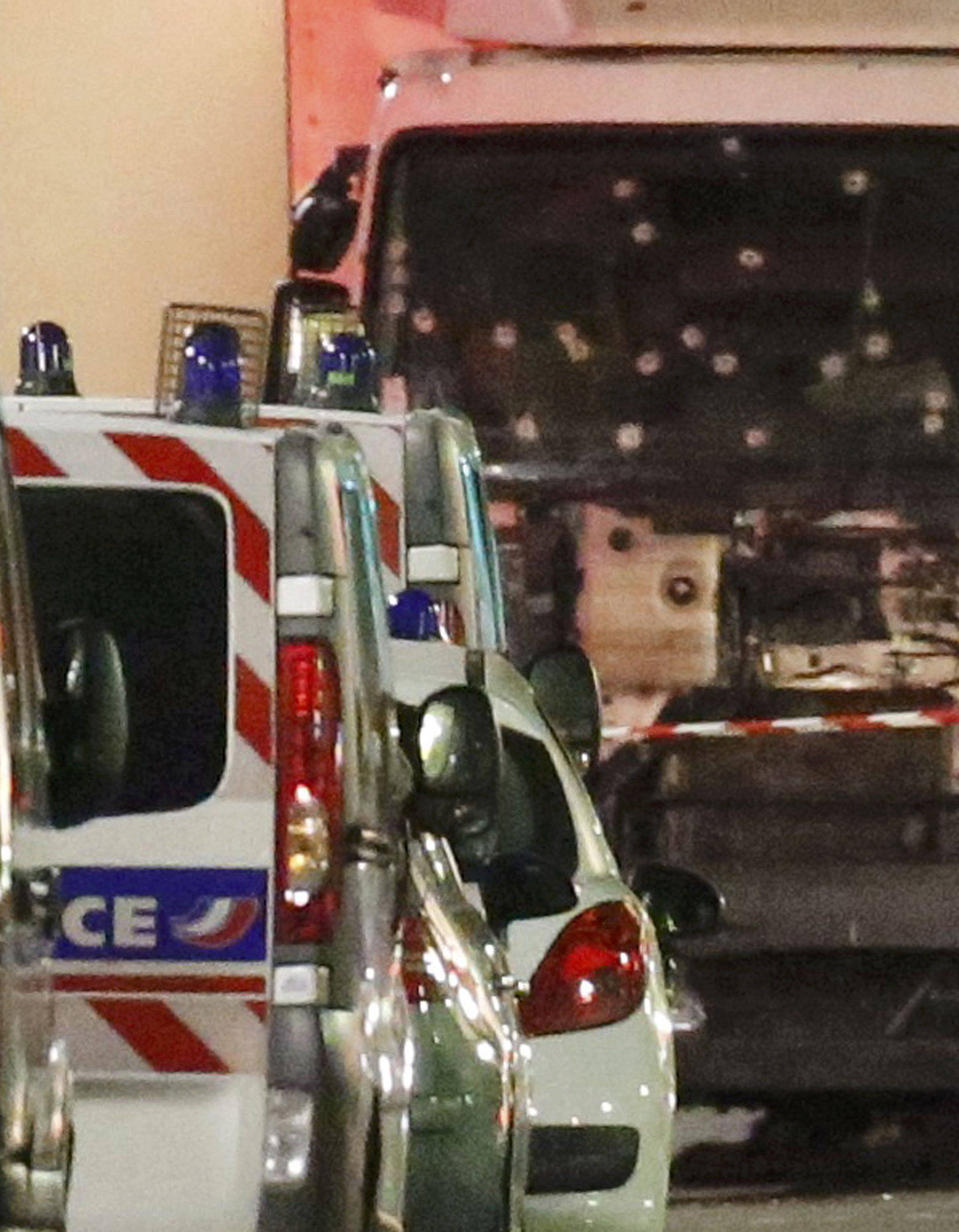 French police forces and forensic officers stand next to a truck that ran into a crowd celebrating the Bastille Day national holiday on the Promenade des Anglais killing at least 60 people in Nice