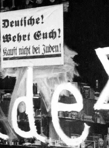 Germany: A Jewish-owned shop vandalized by Nazis with poster reading 'Germans Defend Yourselves - Don't Buy from Jews', 1938