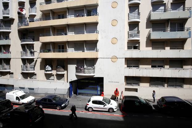 French firefighters secure the street as police conduct an investigation after two Frenchmen were arrested in Marseille