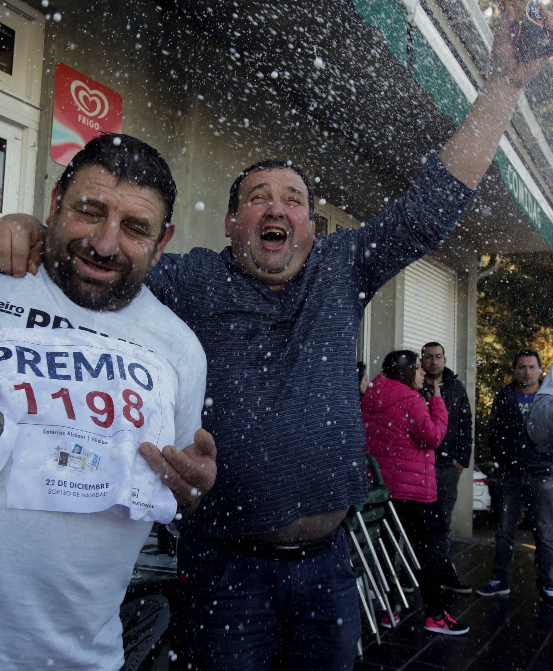 People, who bought winning tickets of the biggest prize of Spain's Christmas Lottery "El Gordo" (The Fat One), celebrate in Vilalba