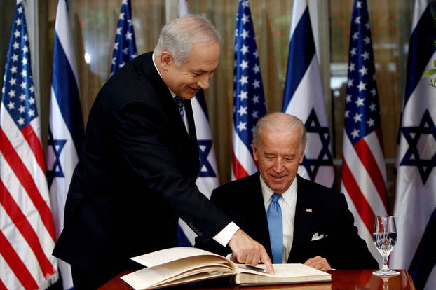 FILE PHOTO: U.S. Vice President Biden prepares to sign the guest book at Netanyahu's residence in Jerusalem