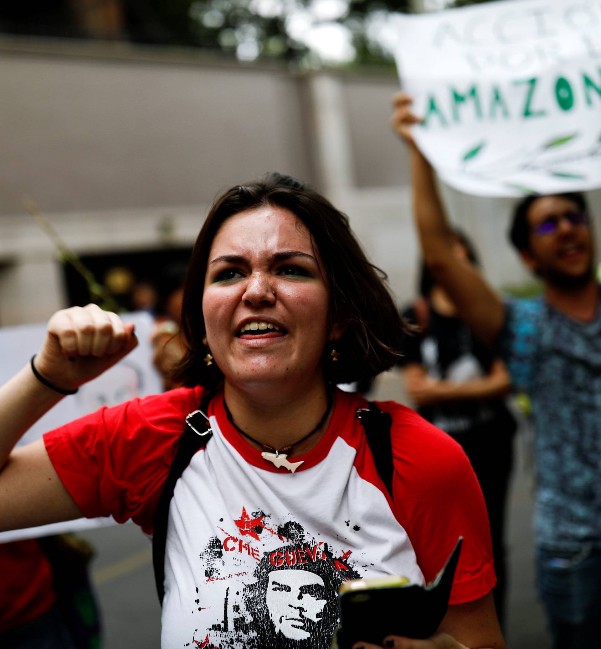 People attend a demonstration to demand more protection for the Amazon rainforest, at the Brazilian embassy in Mexico City