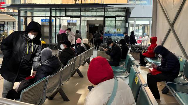 People wait outside a fever clinic at a hospital as coronavirus disease (COVID-19) outbreak continues, in Shanghai