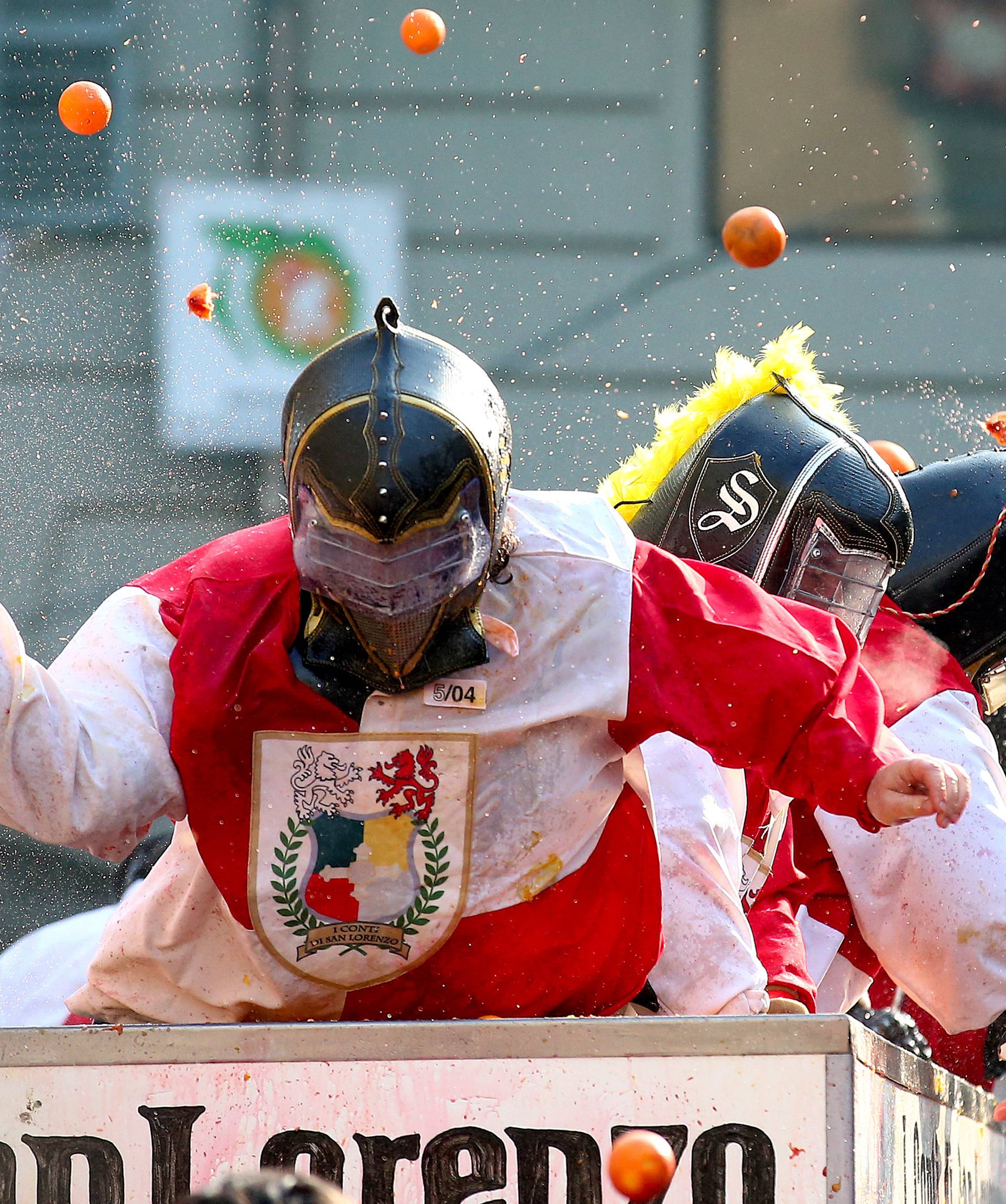 Members of rival teams fight with oranges during an annual carnival battle in the northern Italian town of Ivrea