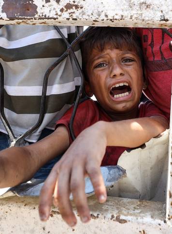 Palestinians receive food from charity kitchen, in Gaza City