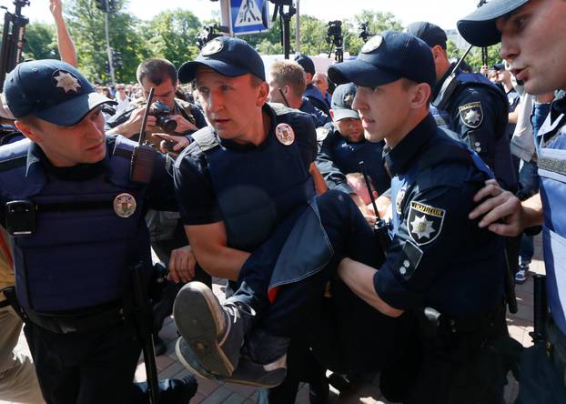 Policemen detain anti-gay protester during Equality March in Kiev