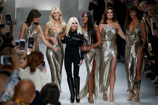 Italian designer Donatella Versace acknowledges the applause with former top models Carla Bruni, Claudia Schiffer, Naomi Campbell, Cindy Crawford and Helena Christensen at the end of Versace Spring/Summer 2018 show at the Milan Fashion Week in Milan