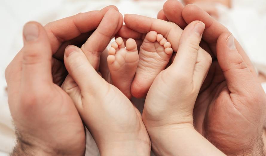 Children's,Feet,In,The,Hands,Of,Mother,And,Father.,The