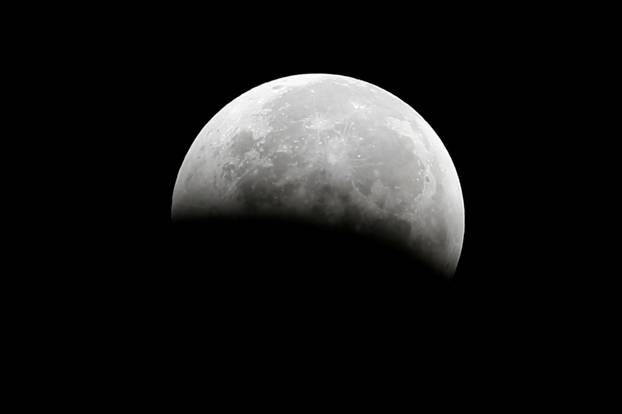 FILE PHOTO: A total lunar eclipse, also known as a "blood moon", is pictured from Santa Monica