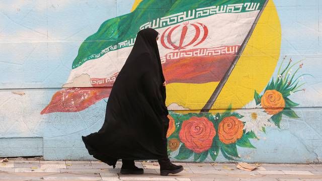 FILE PHOTO: Women walk after morality police shut down in Tehran