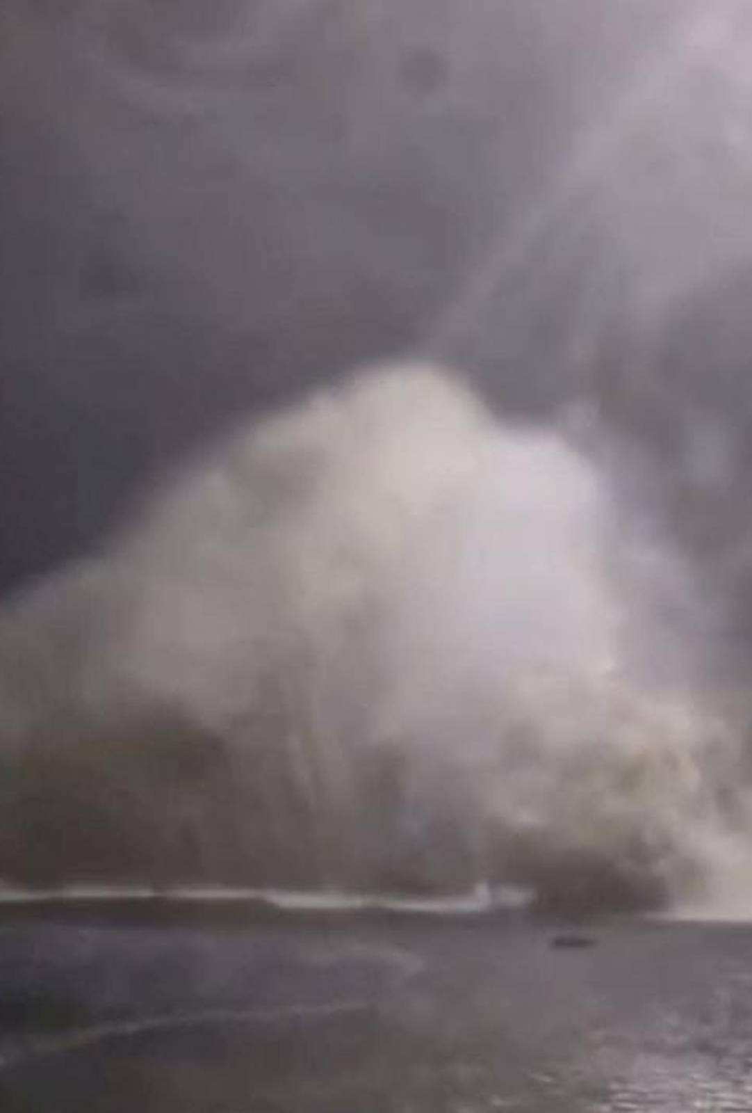 A wave crashes into land as tides rise due to Cyclone Gabrielle in Waiwera, Auckland