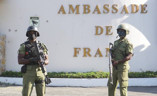 Tanzanian security forces guard an entrance to the French embassy after an attacker wielding an assault rifle was killed in the Salenda area of Dar es Salaam