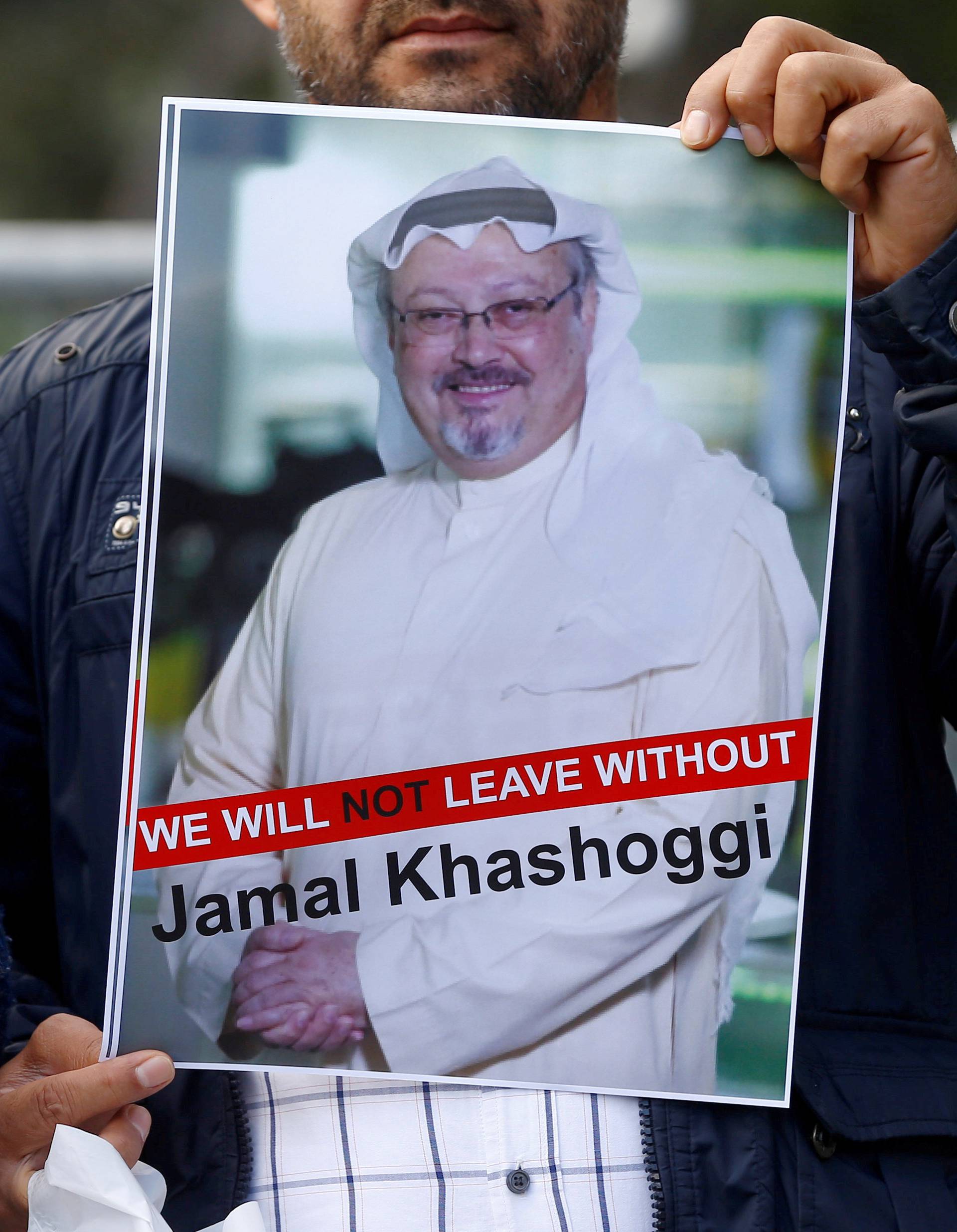 FILE PHOTO: A demonstrator holds picture of Saudi journalist Jamal Khashoggi during a protest in front of Saudi Arabia's consulate in Istanbul