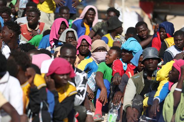 Migrants wait on the Sicilian island of Lampedusa