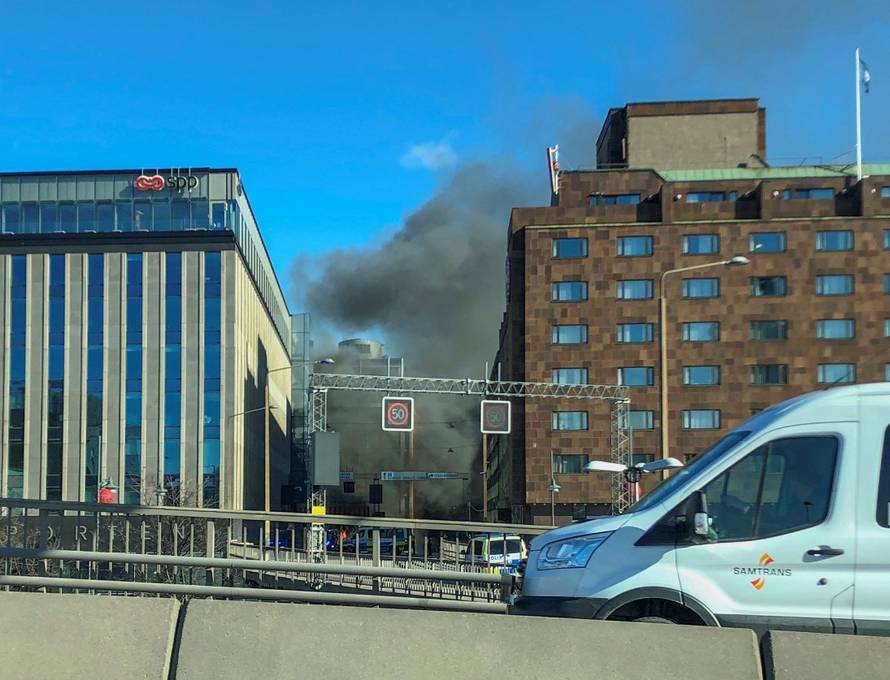 Smoke from a bus explosion and fire is seen in Tegelbacken in central Stockholm