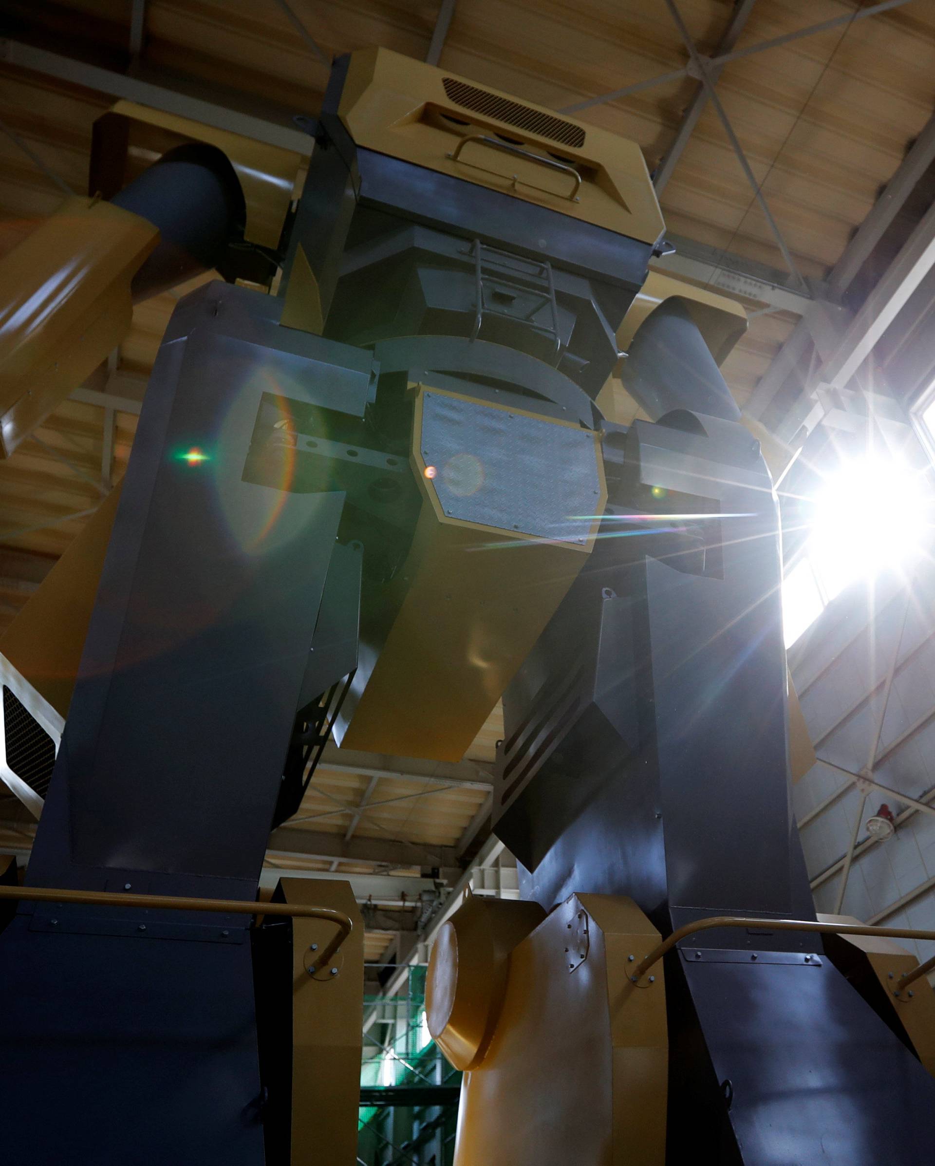 Sakakibara Kikai's engineer Masaaki Nagumo rides a lift to board the bipedal robot Mononofu during its demonstration at its factory in Shinto Village