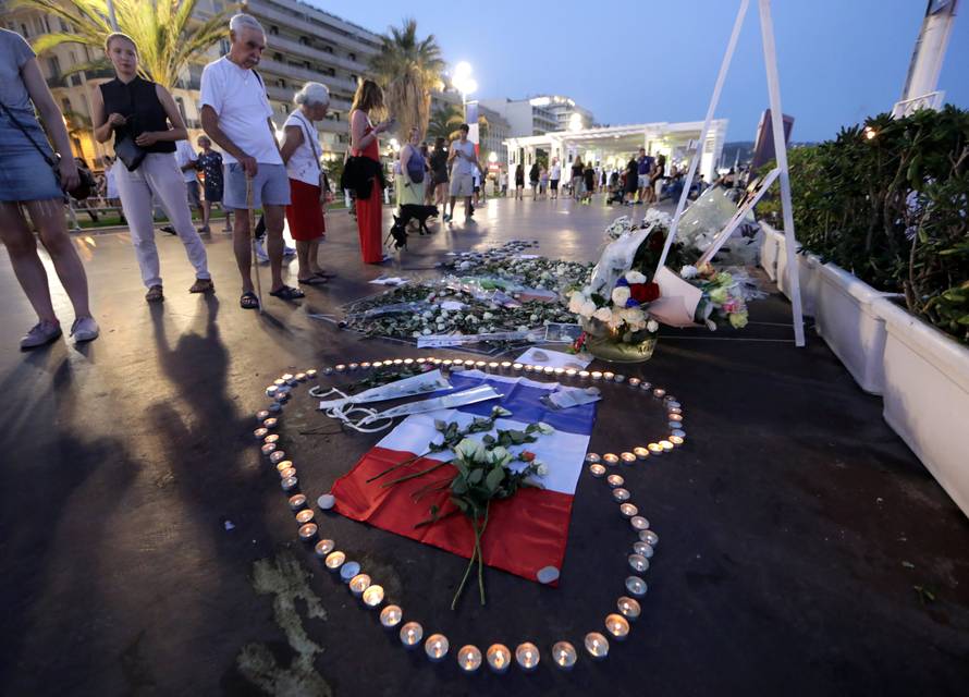 People look at a memorial on the Promenade des Anglais as part of the commemorations of last year's July 14 Bastille Day fatal truck attack in Nice