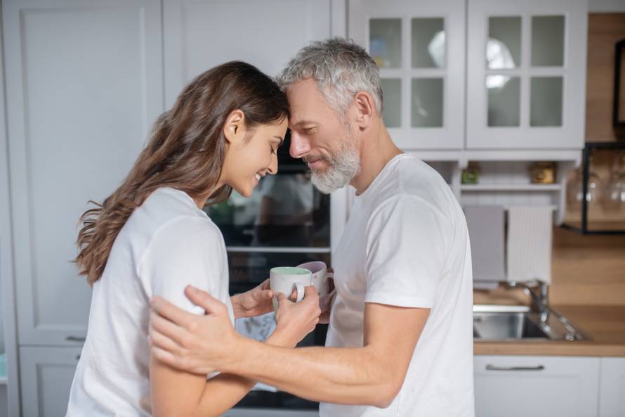 Man and woman hugging each other while having coffee