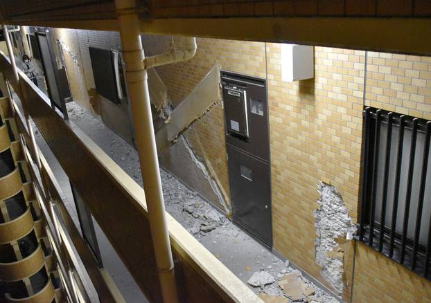 The wall of a condominium building is seen partially collapsed after an eathquake in Fukushima