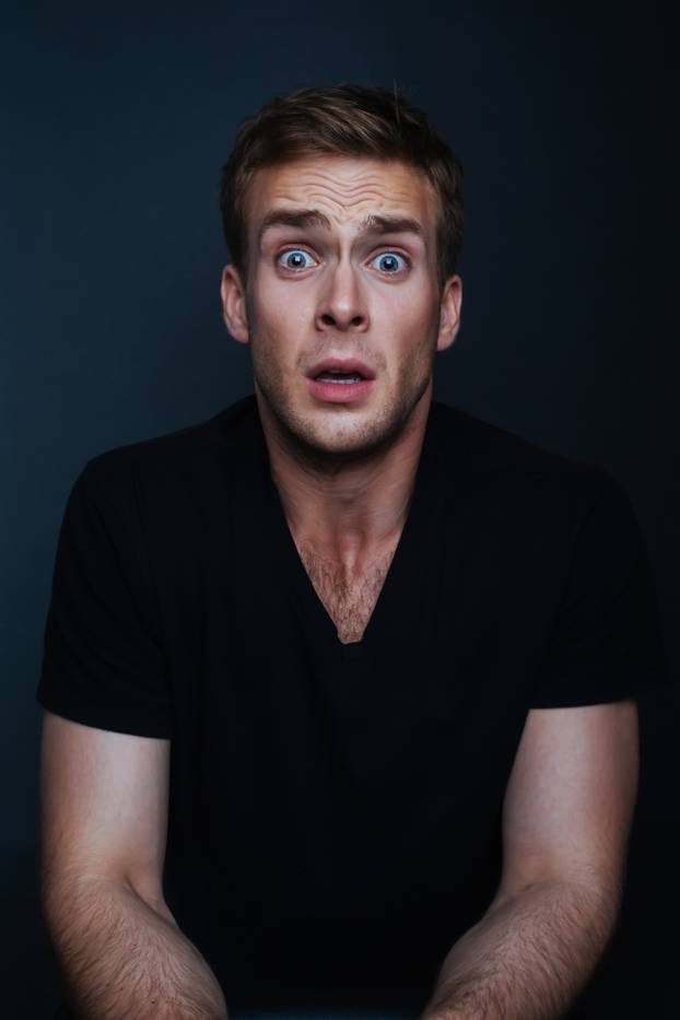 Handsome man is scared of what he has seen