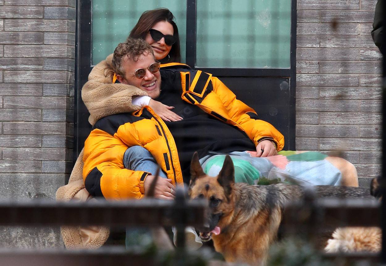 Emily Ratajkowski and husband Sebastian Bear-McClard share a romantic moment as they cuddle each other while watching dogs play at park in NYC
