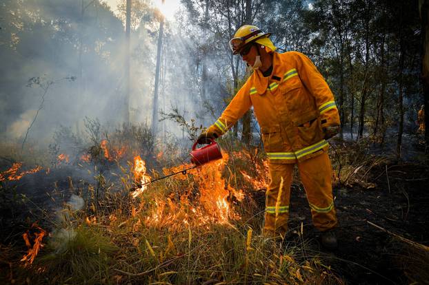 A supplied image obtained January 8, 2020 shows Country Fire Authority (CFA) strike teams performing controlled burning west of Corryong