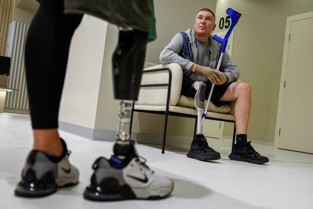 Former Ukrainian service members, who were wounded at a front line, come to a clinic to treat scars, in Kyiv