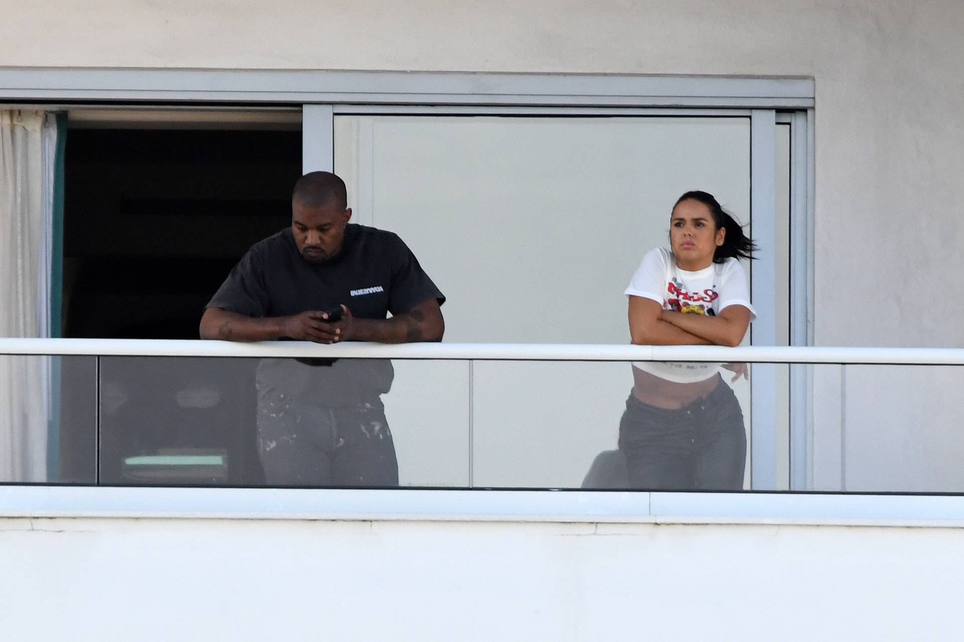 PREMIUM EXCLUSIVE:  A scantily-clad girl emerges from Kanye Wests hotel room as the rapper enjoys a relaxing New Years break in Miami.