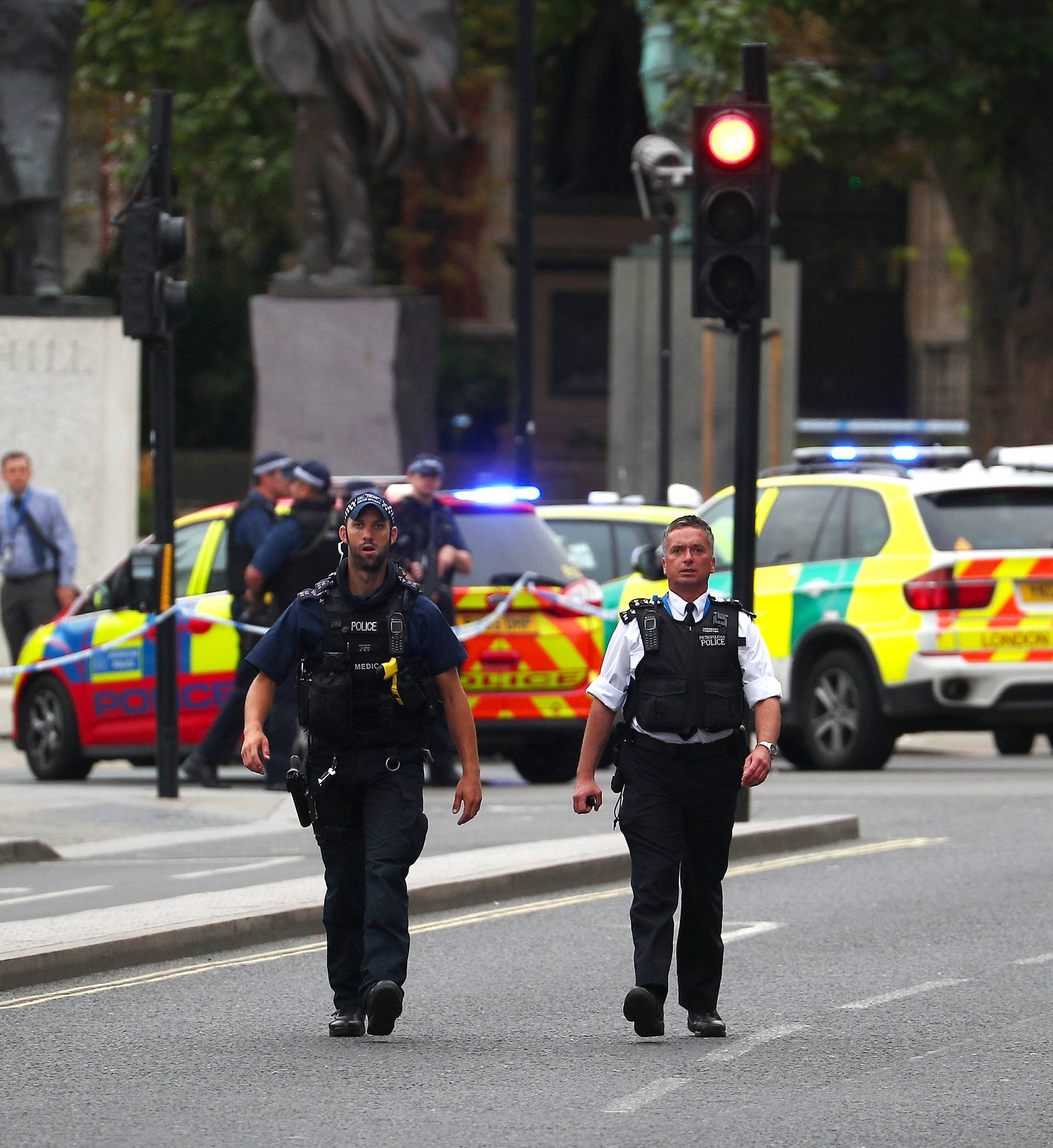 Armed police stand in the street after a car crashed outside the Houses of Parliament in Westminster, London