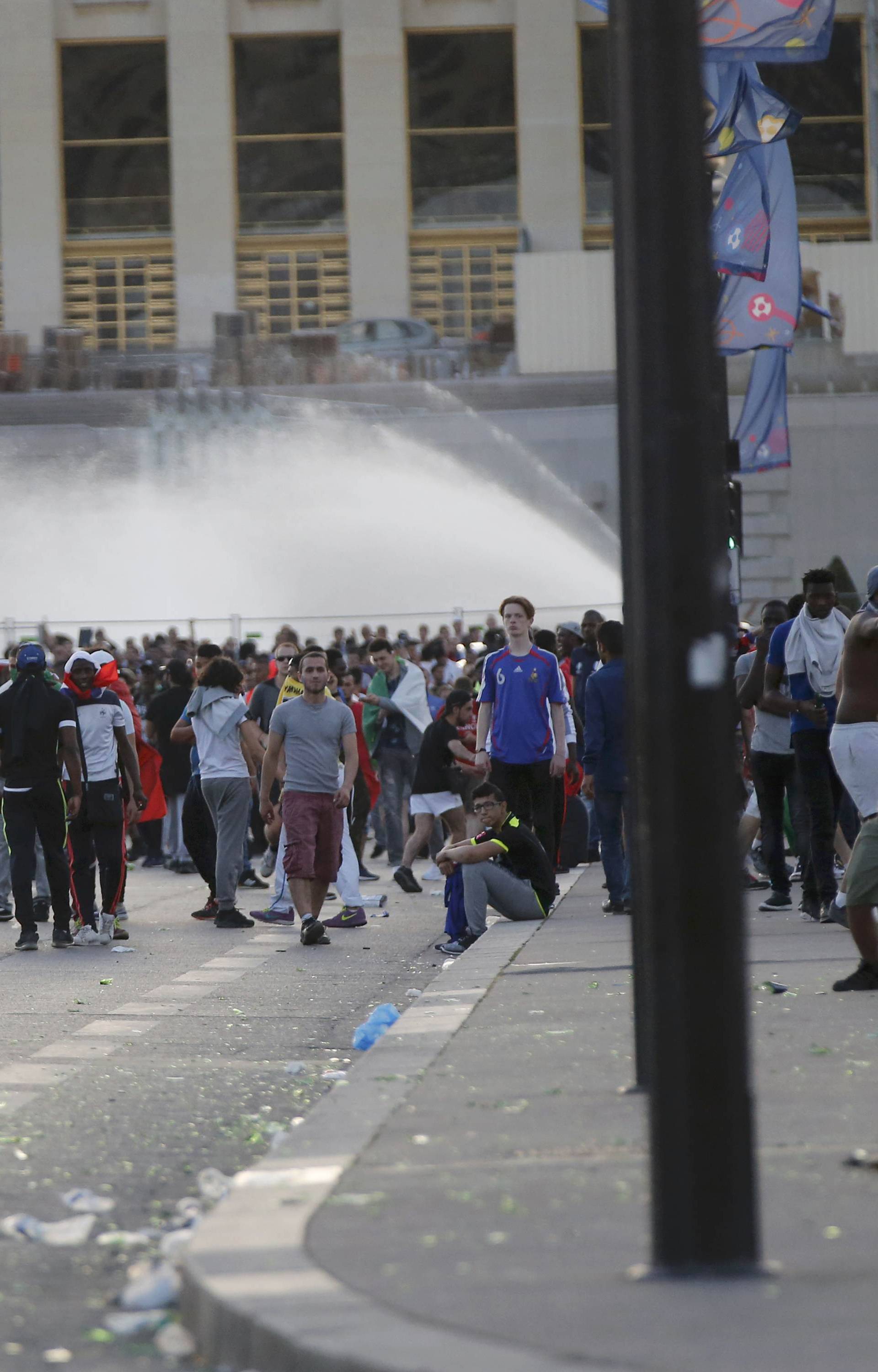 French riot police face off with youths outside the Paris fan zone during a EURO 2016 final soccer match       