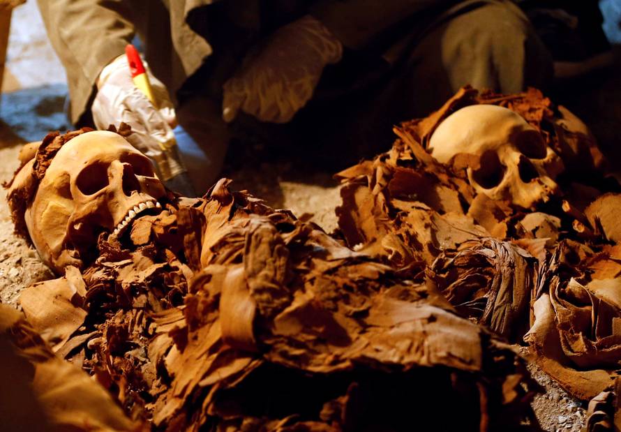An Egyptian antiquities worker works in the recently discovered tomb of Amenemhat, a goldsmith from the New Kingdom, at the Draa Abu-el Naga necropolis near the Nile city of Luxor
