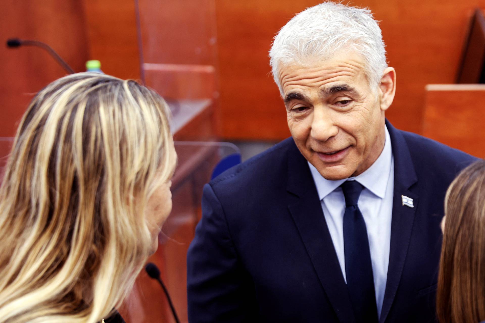 Israeli opposition leader Yair Lapid speaks to people at the Jerusalem District Court before he is due to testify in Prime Minister Benjamin Netanyahu's corruption trial in Jerusalem