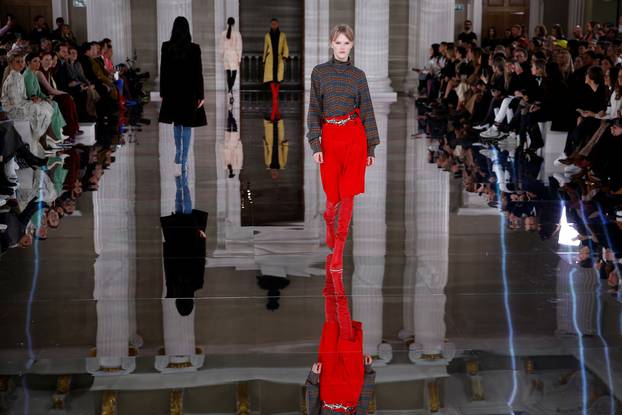 Models present creations at the Victoria Beckham catwalk show during London Fashion Week in London