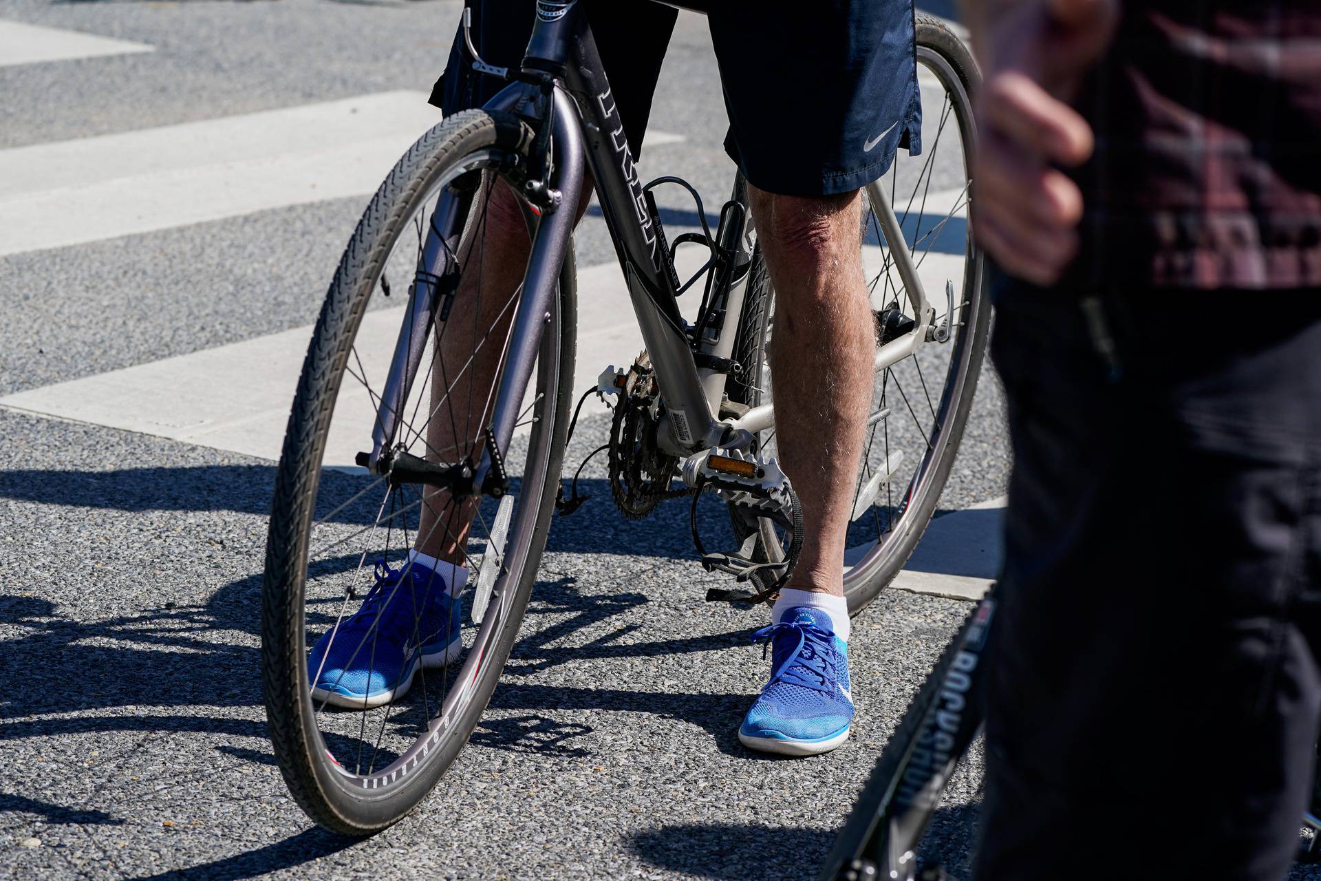 U.S. President Joe Biden rides a bike in Rehoboth Beach, Delaware