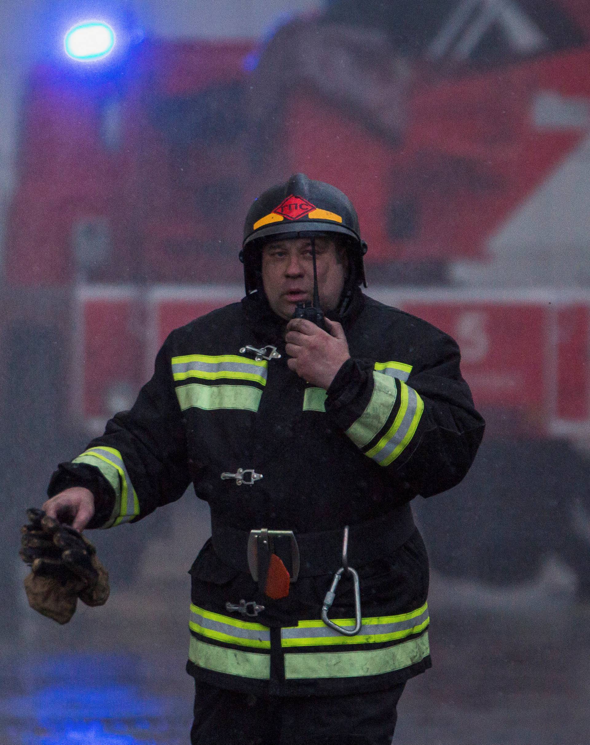 A member of the Emergency Situations Ministry works at the scene of a fire in a shopping mall in Kemerovo